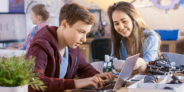 Menino e menina olhando tela do computador. 